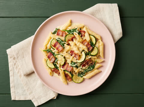 Creamy bacon penne with zucchini and greens